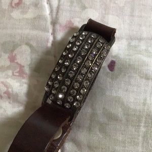 Crystal bracelet with brown soft leather straps that snap closed at the end.